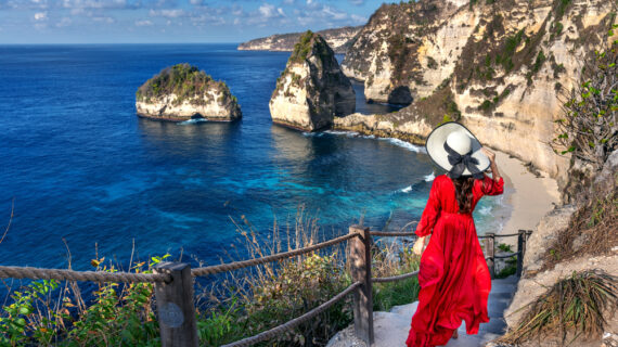 Woman standing on Diamond beach in Nusa penida island, Bali in Indonesia.